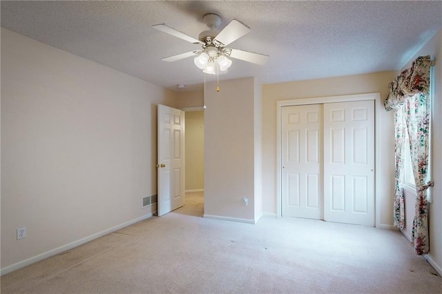 1404 NE Piedmont Dr, Lees Summit, MO 64064 - unfurnished bedroom featuring carpet flooring, a closet, a textured ceiling, a ceiling fan, and baseboards