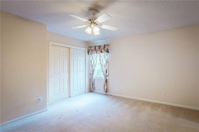 1404 NE Piedmont Dr, Lees Summit, MO 64064 - unfurnished bedroom with light carpet, a closet, baseboards, a textured ceiling, and ceiling fan