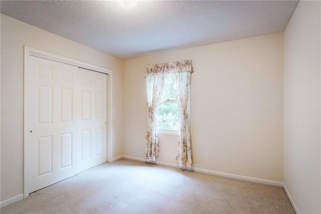 1404 NE Piedmont Dr, Lees Summit, MO 64064 - unfurnished bedroom featuring carpet, a closet, a textured ceiling, and baseboards
