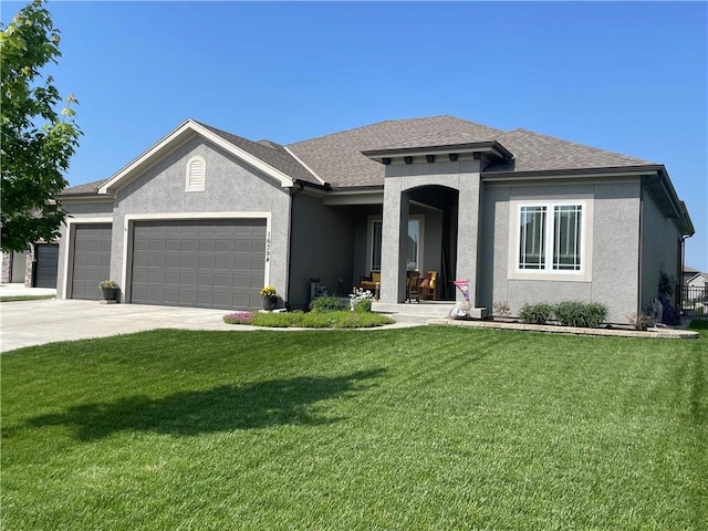 16394 S Loiret St, Olathe, KS 66062 - view of front of property with an attached garage, stucco siding, a front lawn, driveway, and roof with shingles