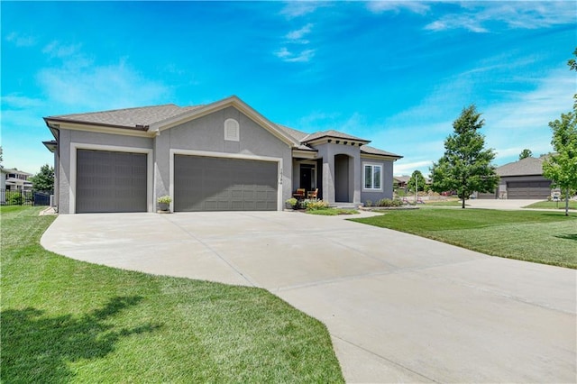 16394 S Loiret St, Olathe, KS 66062 - view of front of property with a garage, driveway, a front lawn, and stucco siding