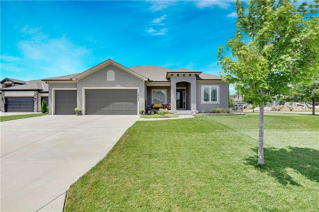 16394 S Loiret St, Olathe, KS 66062 - view of front of home featuring an attached garage, stucco siding, a front yard, and driveway