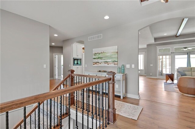 16394 S Loiret St, Olathe, KS 66062 - corridor with arched walkways, light wood-style flooring, an upstairs landing, and recessed lighting