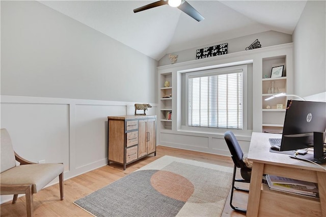 16394 S Loiret St, Olathe, KS 66062 - home office featuring a ceiling fan, a decorative wall, light wood-type flooring, built in shelves, and wainscoting