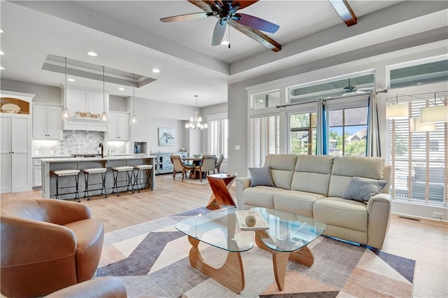 16394 S Loiret St, Olathe, KS 66062 - living area with healthy amount of natural light, ceiling fan, recessed lighting, a chandelier, and a raised ceiling