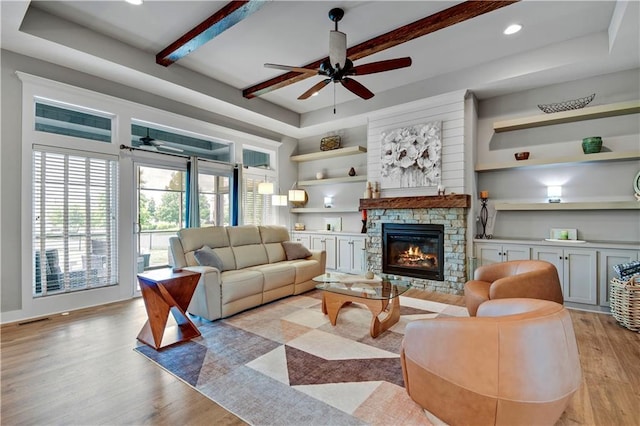 16394 S Loiret St, Olathe, KS 66062 - living area with ceiling fan, light wood-style flooring, a fireplace, beam ceiling, and recessed lighting