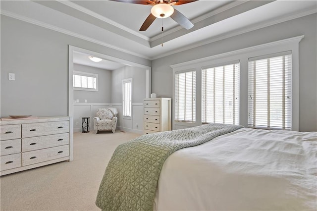 16394 S Loiret St, Olathe, KS 66062 - bedroom featuring light carpet, crown molding, a tray ceiling, wainscoting, and a ceiling fan