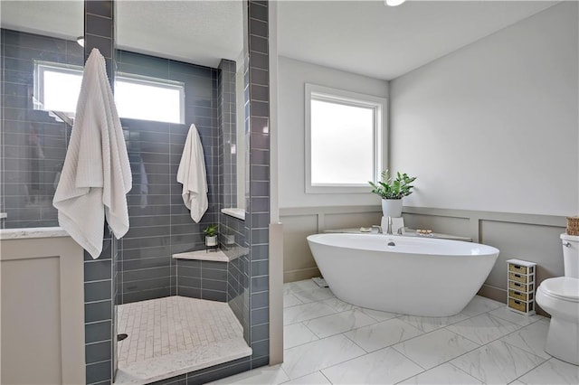 16394 S Loiret St, Olathe, KS 66062 - full bath featuring marble look tiles, a freestanding bath, a tile shower, and wainscoting