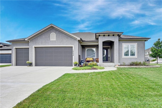 16394 S Loiret St, Olathe, KS 66062 - view of front of home with an attached garage, concrete driveway, a front yard, and stucco siding