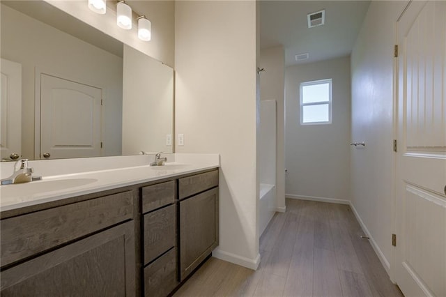 27027 E Oak View Dr, Lees Summit, MO 64086 - full bath featuring double vanity, wood finished floors, baseboards, and  shower combination