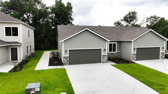 789 Highland Dr, Edwardsville, KS 66111 - view of front of home with concrete driveway, a front lawn, and an attached garage