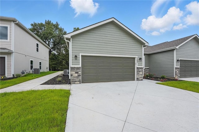 789 Highland Dr, Edwardsville, KS 66111 - view of front of home with stone siding, cooling unit, and a front yard