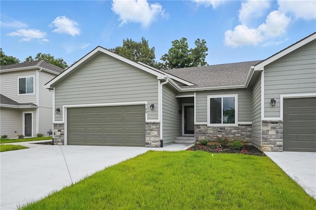 789 Highland Dr, Edwardsville, KS 66111 - view of front of home with concrete driveway, stone siding, an attached garage, and a front yard
