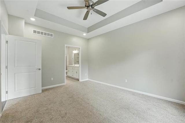 789 Highland Dr, Edwardsville, KS 66111 - spare room with light carpet, recessed lighting, baseboards, a ceiling fan, and a tray ceiling