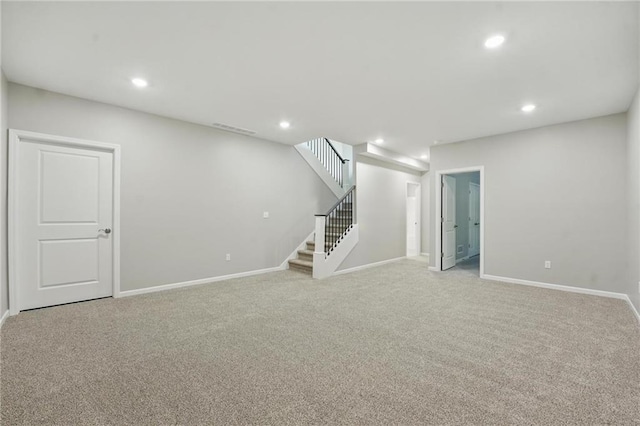 789 Highland Dr, Edwardsville, KS 66111 - below grade area with light colored carpet, baseboards, stairs, and recessed lighting