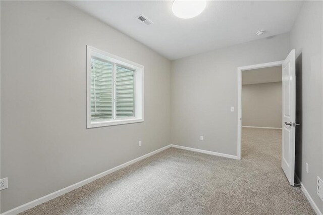 789 Highland Dr, Edwardsville, KS 66111 - carpeted empty room with baseboards and a smoke detector