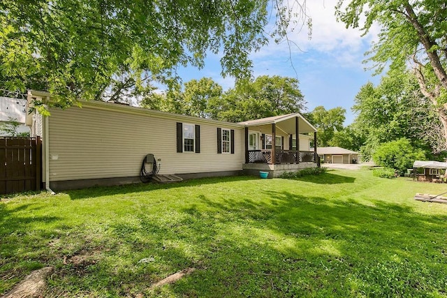415 E Hulett St, Edgerton, KS 66021 - back of property featuring a detached garage and covered porch