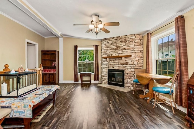 415 E Hulett St, Edgerton, KS 66021 - living room featuring a ceiling fan, a fireplace, wood-type flooring, ornamental molding, and baseboards