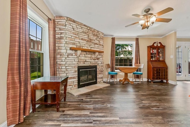 415 E Hulett St, Edgerton, KS 66021 - living area with crown molding, wood finished floors, a fireplace, baseboards, and a ceiling fan