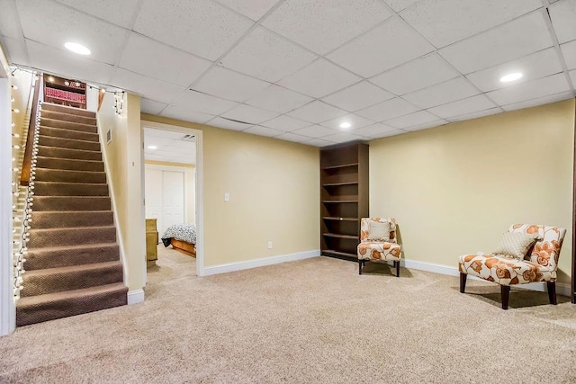 415 E Hulett St, Edgerton, KS 66021 - living area with carpet flooring, stairway, baseboards, and recessed lighting