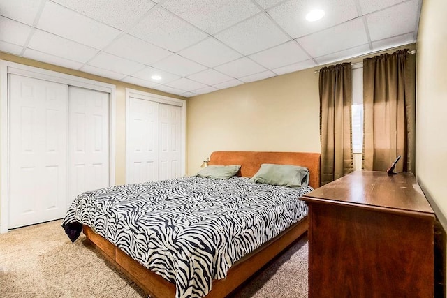 415 E Hulett St, Edgerton, KS 66021 - carpeted bedroom featuring two closets, a paneled ceiling, and recessed lighting