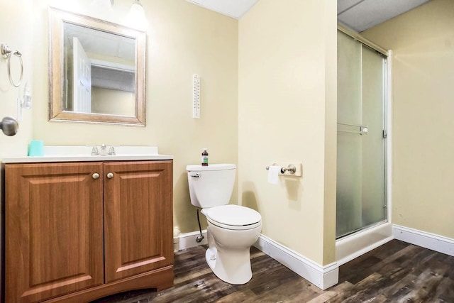415 E Hulett St, Edgerton, KS 66021 - full bathroom with wood finished floors, a shower stall, vanity, toilet, and baseboards
