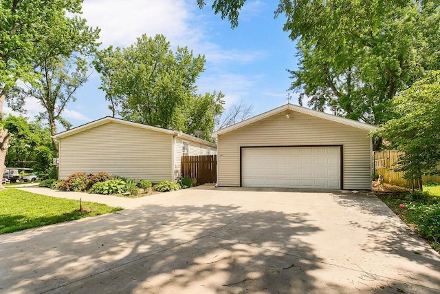 415 E Hulett St, Edgerton, KS 66021 - view of front facade featuring a garage and an outbuilding