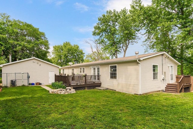 415 E Hulett St, Edgerton, KS 66021 - rear view of property with a deck and a lawn