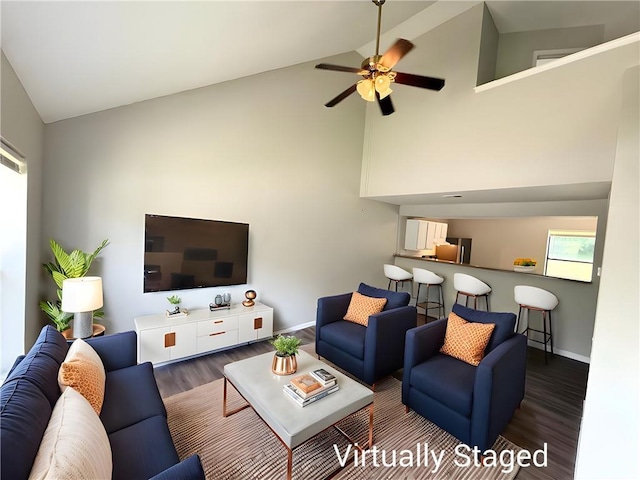 7134 Agnes Ave, Kansas City, MO 64132 - living room with wood finished floors, baseboards, high vaulted ceiling, and ceiling fan