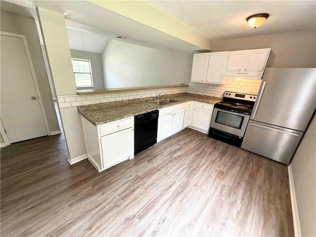 7134 Agnes Ave, Kansas City, MO 64132 - kitchen with appliances with stainless steel finishes, a sink, wood finished floors, white cabinetry, and lofted ceiling