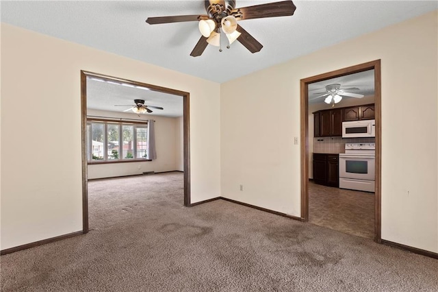 120 Highland Rd, Lansing, KS 66043 - carpeted spare room with a ceiling fan and baseboards
