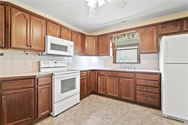 120 Highland Rd, Lansing, KS 66043 - kitchen with white appliances, a sink, light countertops, and ceiling fan