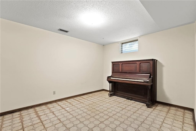 120 Highland Rd, Lansing, KS 66043 - unfurnished room featuring light floors, a textured ceiling, and baseboards