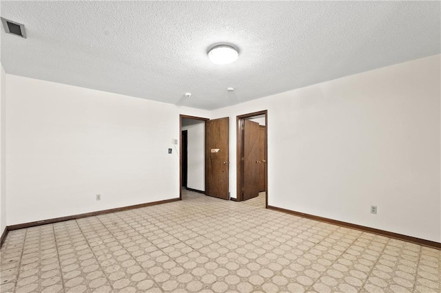 120 Highland Rd, Lansing, KS 66043 - spare room featuring baseboards, light flooring, and a textured ceiling