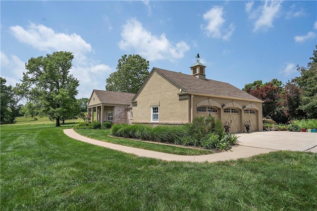 450 Ruth Ewing Rd, Liberty, MO 64068 - view of home's exterior with stucco siding, a lawn, concrete driveway, and an attached garage
