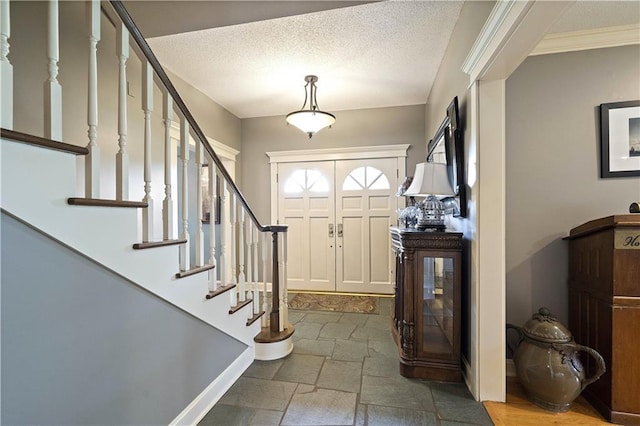 450 Ruth Ewing Rd, Liberty, MO 64068 - foyer entrance with stairway, stone tile floors, baseboards, a textured ceiling, and crown molding