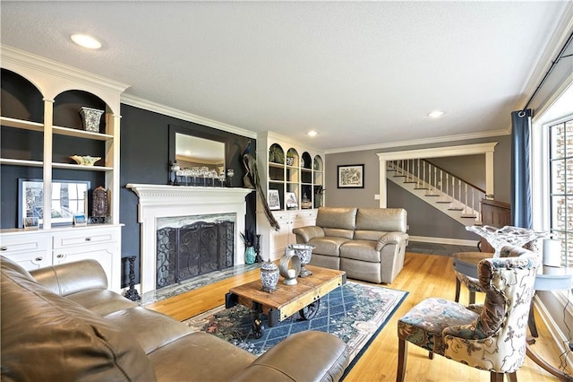 450 Ruth Ewing Rd, Liberty, MO 64068 - living area featuring stairs, a fireplace, wood finished floors, baseboards, and crown molding