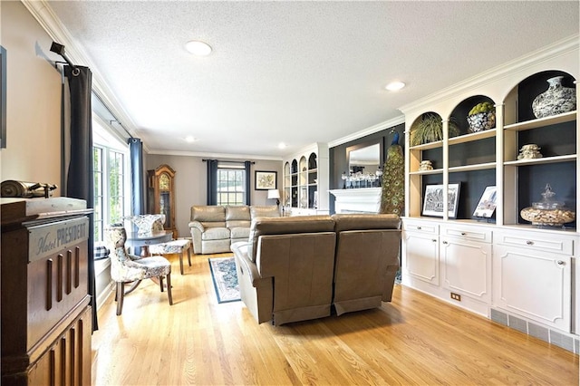 450 Ruth Ewing Rd, Liberty, MO 64068 - living room with crown molding, a textured ceiling, light wood-type flooring, and recessed lighting