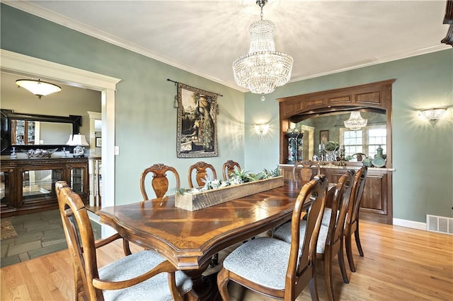 450 Ruth Ewing Rd, Liberty, MO 64068 - dining space with a chandelier, crown molding, light wood-style flooring, and baseboards