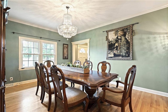 450 Ruth Ewing Rd, Liberty, MO 64068 - dining area with a chandelier, light wood-type flooring, baseboards, and ornamental molding