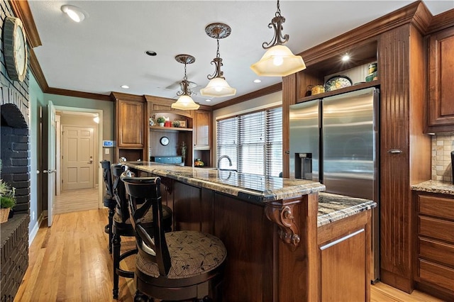 450 Ruth Ewing Rd, Liberty, MO 64068 - kitchen featuring open shelves, crown molding, stainless steel fridge with ice dispenser, a breakfast bar, and light stone counters