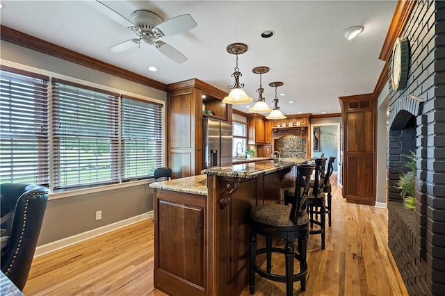450 Ruth Ewing Rd, Liberty, MO 64068 - kitchen featuring baseboards, stainless steel fridge, crown molding, ceiling fan, and light wood-style floors