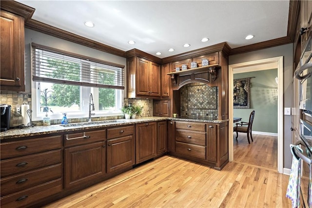 450 Ruth Ewing Rd, Liberty, MO 64068 - kitchen featuring crown molding, a sink, light stone countertops, baseboards, and backsplash
