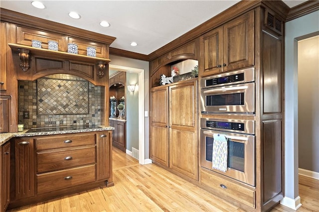 450 Ruth Ewing Rd, Liberty, MO 64068 - kitchen with stainless steel double oven, open shelves, backsplash, black electric stovetop, and light stone countertops