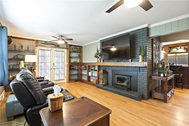 450 Ruth Ewing Rd, Liberty, MO 64068 - living area featuring a ceiling fan, crown molding, wood finished floors, a textured ceiling, and french doors