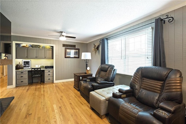 450 Ruth Ewing Rd, Liberty, MO 64068 - living room with crown molding, light wood finished floors, a ceiling fan, baseboards, and a textured ceiling