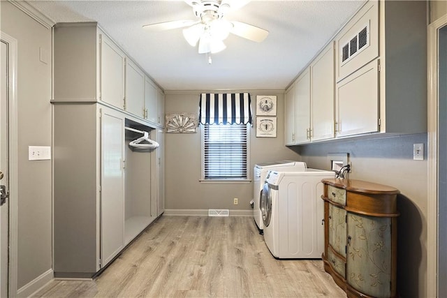 450 Ruth Ewing Rd, Liberty, MO 64068 - laundry room with washer and clothes dryer, cabinet space, light wood-type flooring, a ceiling fan, and baseboards