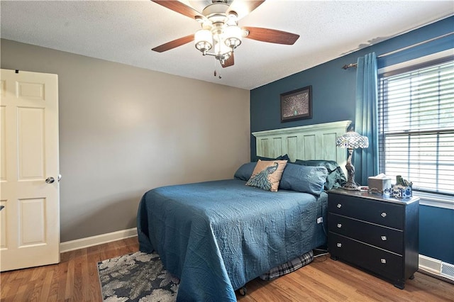 450 Ruth Ewing Rd, Liberty, MO 64068 - bedroom featuring multiple windows, wood finished floors, a ceiling fan, and baseboards