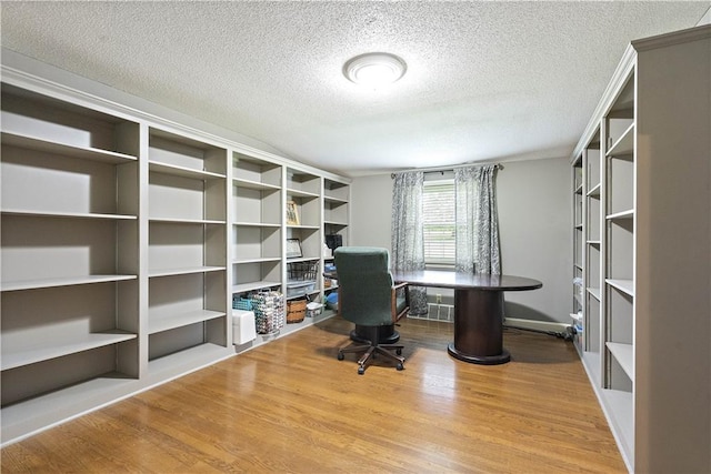 450 Ruth Ewing Rd, Liberty, MO 64068 - office space featuring wood finished floors and a textured ceiling