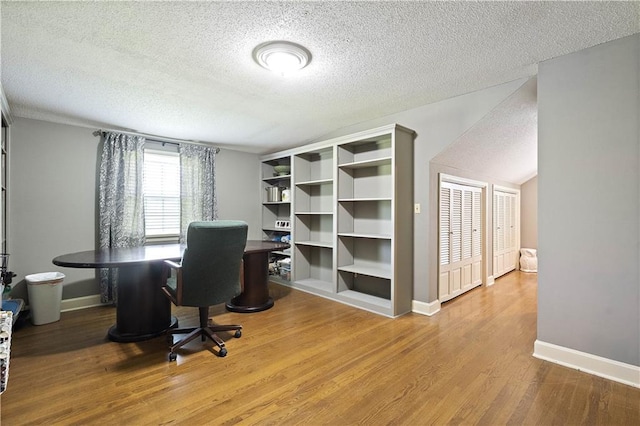 450 Ruth Ewing Rd, Liberty, MO 64068 - office space with a textured ceiling, wood finished floors, and baseboards
